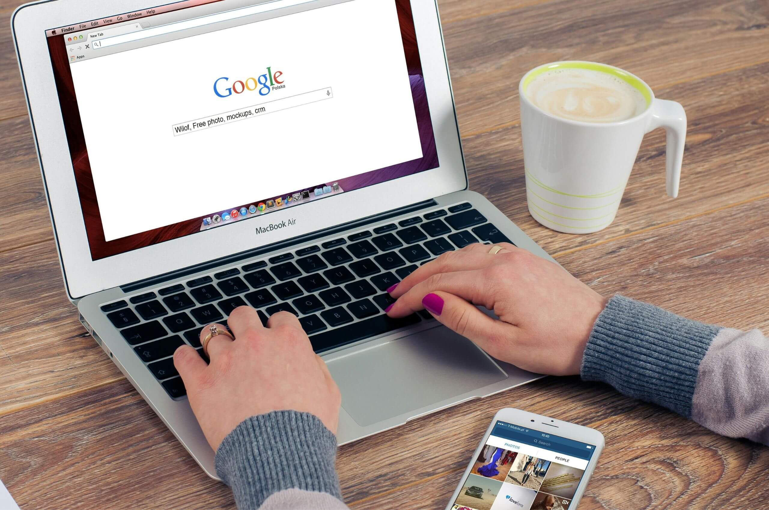A person searching for a search query on Google search using their laptop