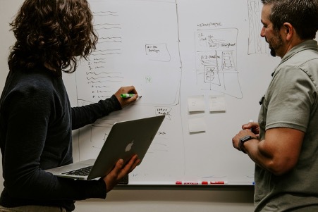 Two men at a whiteboard